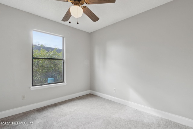 unfurnished room featuring ceiling fan and carpet flooring