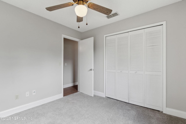 unfurnished bedroom featuring light colored carpet, ceiling fan, and a closet