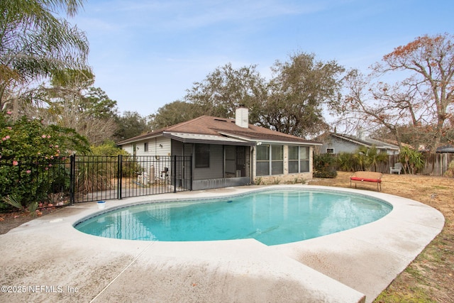 view of swimming pool with a sunroom