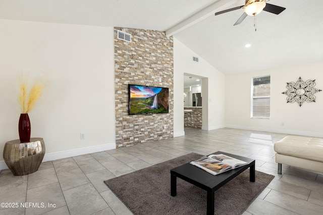 living room with a textured ceiling, ceiling fan, light tile patterned flooring, and lofted ceiling with beams