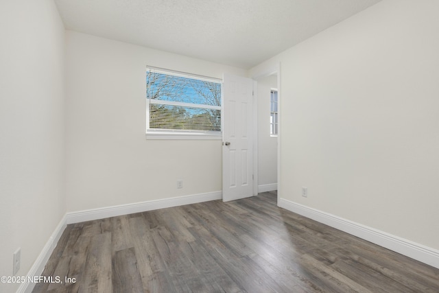 unfurnished room featuring dark hardwood / wood-style floors