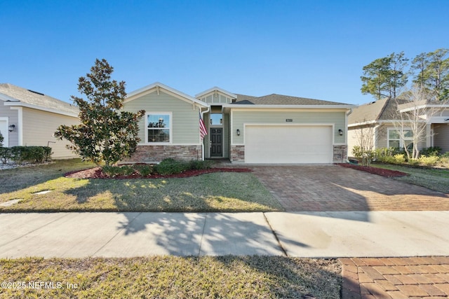 view of front facade with a front yard and a garage