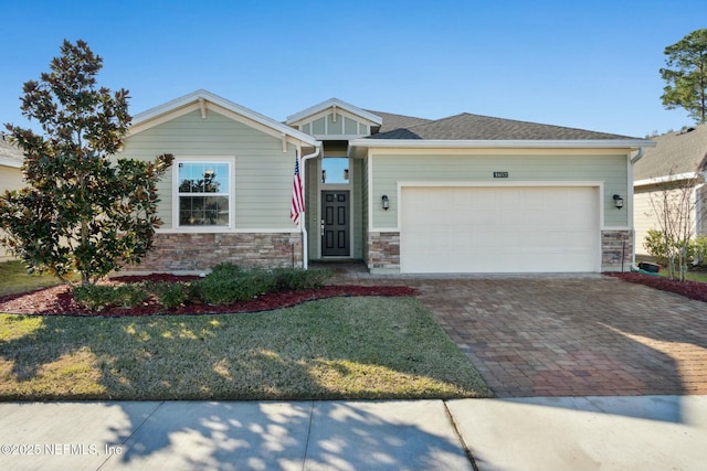 craftsman-style home featuring a front lawn and a garage