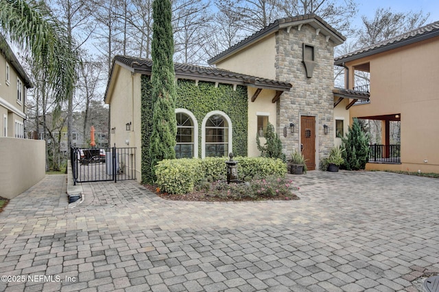 mediterranean / spanish-style house with a balcony