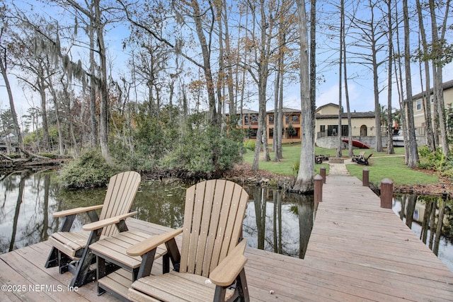 dock area featuring a water view and a yard