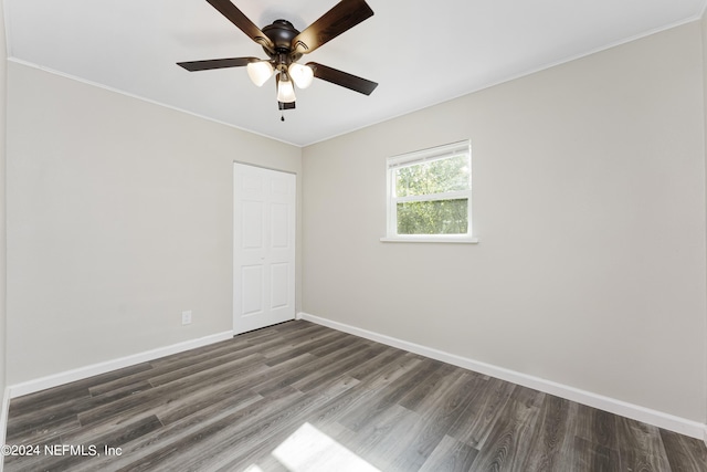 empty room featuring ceiling fan and dark hardwood / wood-style floors