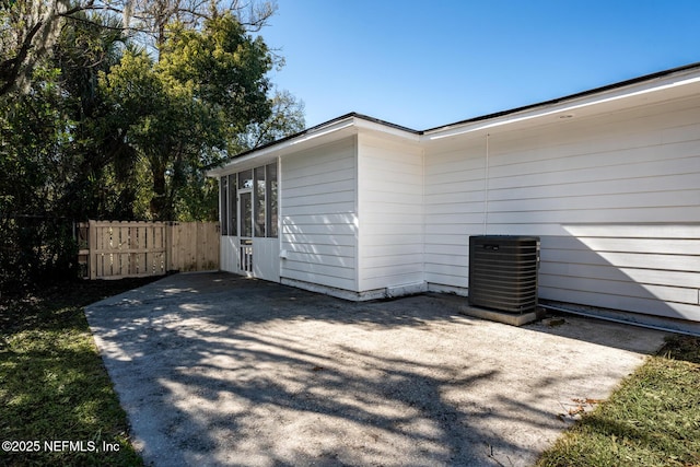 view of property exterior with central AC unit and a patio