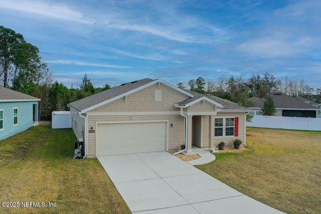 view of front of home with a front yard and a garage