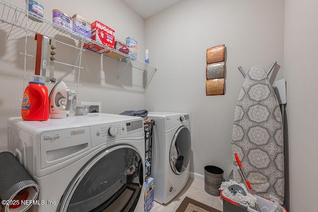 laundry room featuring light tile patterned flooring and separate washer and dryer