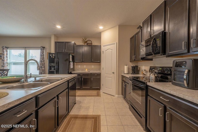 kitchen with sink, dark brown cabinetry, black appliances, and light tile patterned flooring