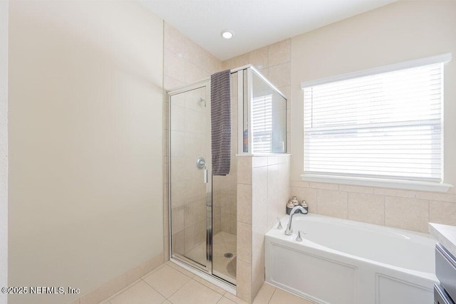 bathroom featuring independent shower and bath, tile patterned flooring, and vanity