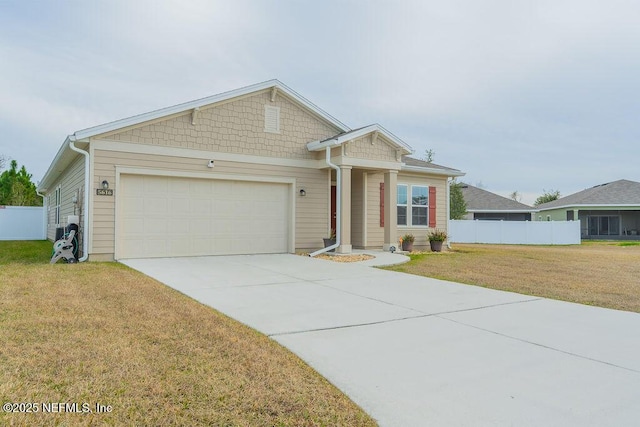 view of front of home with a front yard and a garage