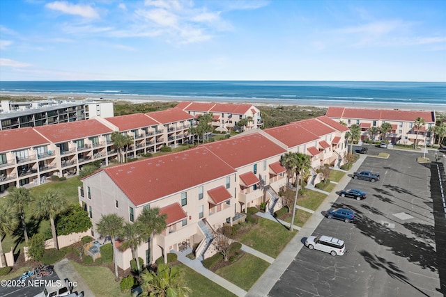 birds eye view of property featuring a water view and a view of the beach