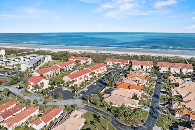 birds eye view of property with a water view and a view of the beach