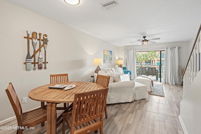 bedroom with ceiling fan, access to exterior, a textured ceiling, and light wood-type flooring