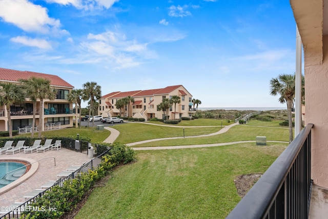 view of home's community featuring a yard and a patio