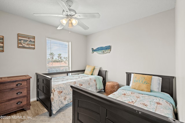 bedroom with ceiling fan and light hardwood / wood-style flooring