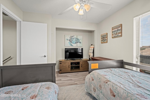 bedroom with ceiling fan and light hardwood / wood-style flooring