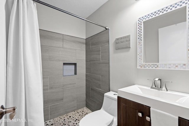 bathroom featuring toilet, a shower with curtain, and vanity