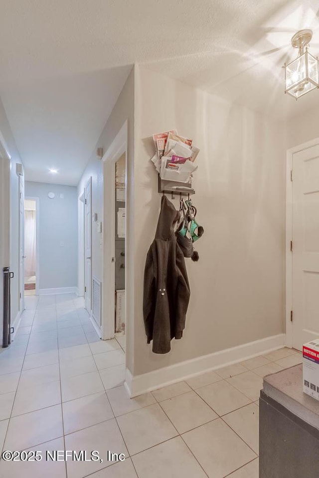 hall featuring light tile patterned flooring