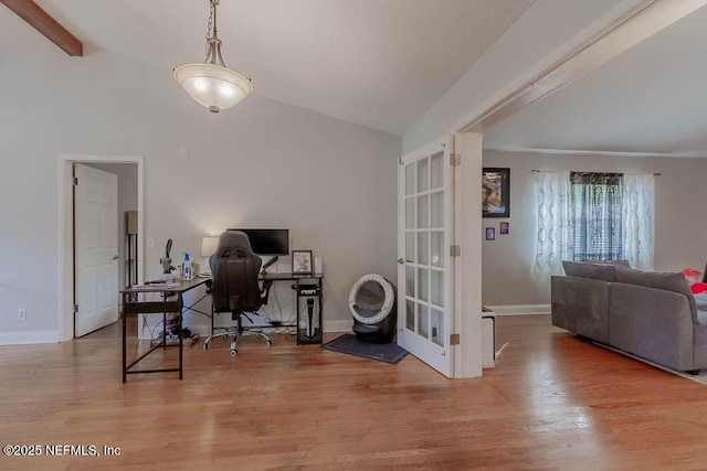 office area featuring light hardwood / wood-style floors and vaulted ceiling with beams