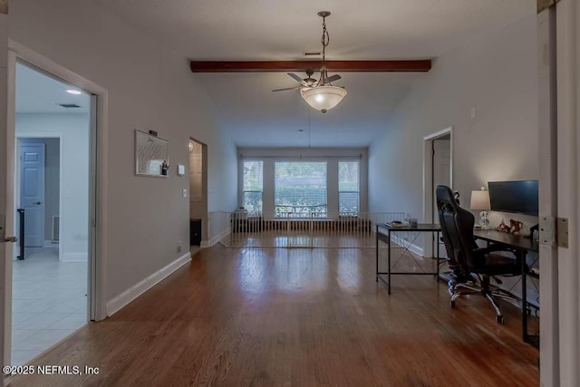 interior space featuring hardwood / wood-style flooring, ceiling fan, and vaulted ceiling with beams