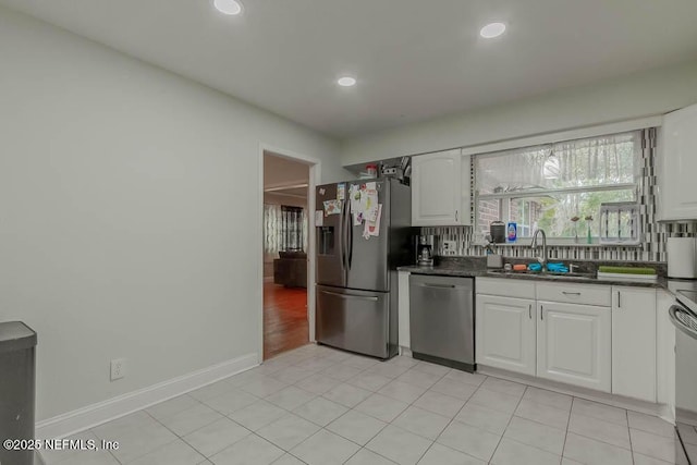 kitchen with sink, white cabinetry, appliances with stainless steel finishes, and tasteful backsplash