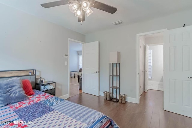 bedroom with ceiling fan and dark wood-type flooring