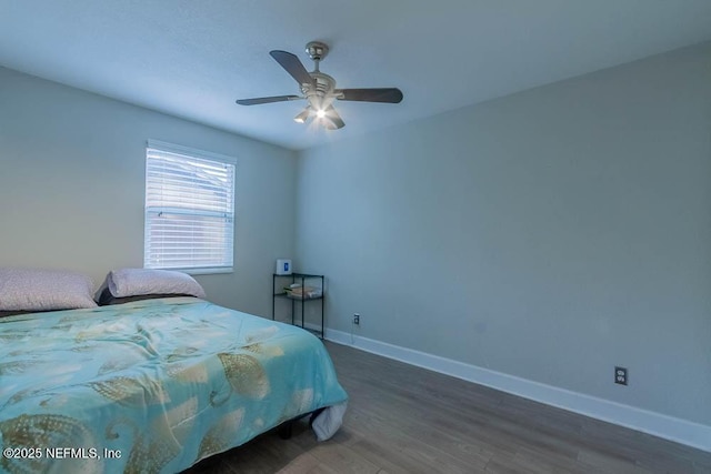 bedroom featuring ceiling fan and dark hardwood / wood-style floors