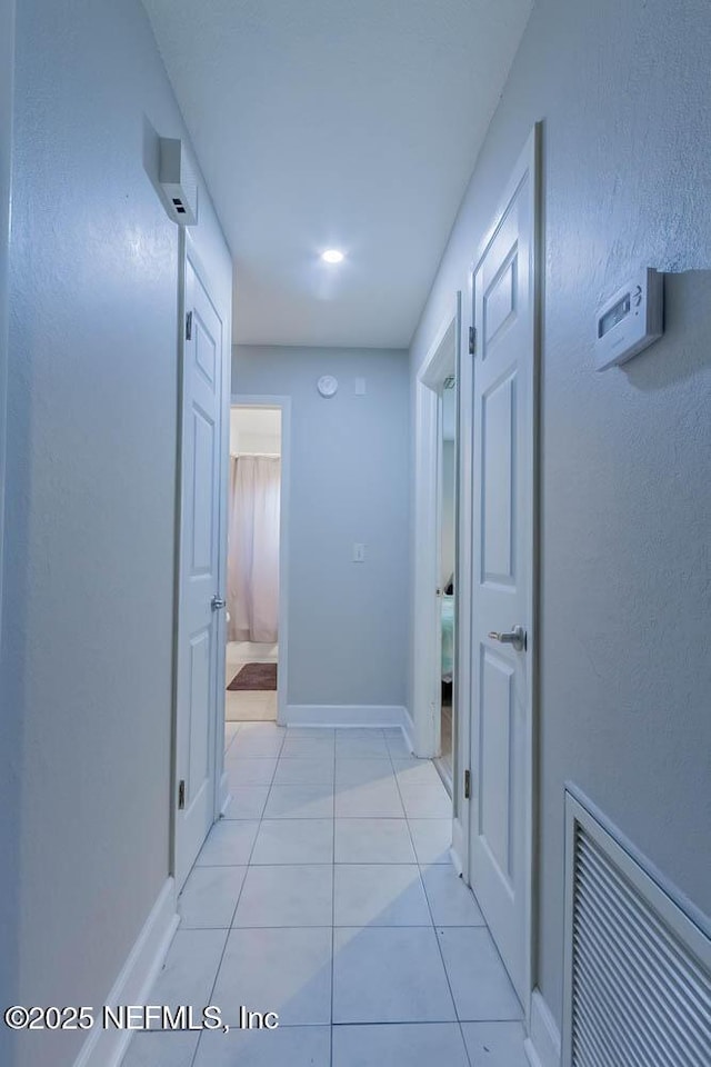 hallway featuring light tile patterned floors