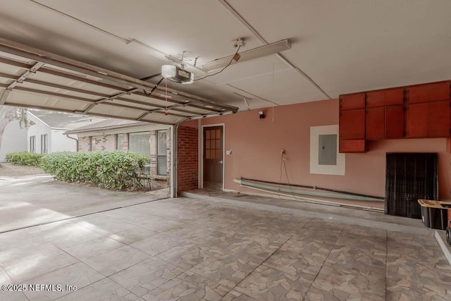 garage featuring a garage door opener and electric panel