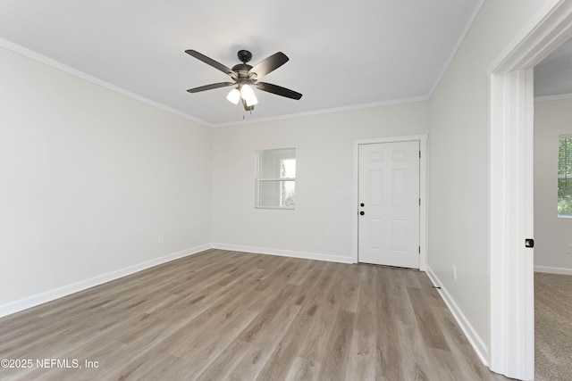 empty room with light wood-type flooring, ceiling fan, and crown molding