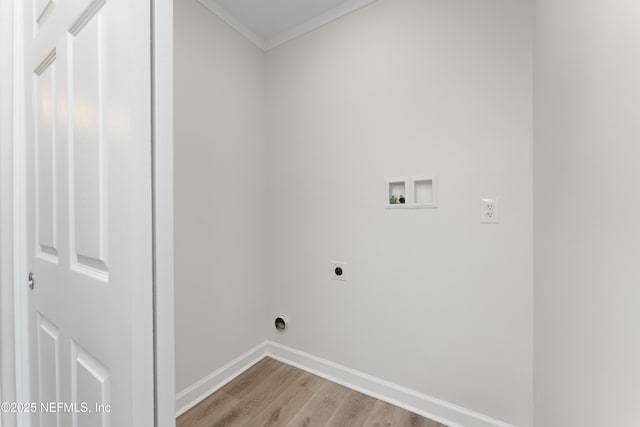 laundry room with hookup for a washing machine, crown molding, hookup for an electric dryer, and light wood-type flooring