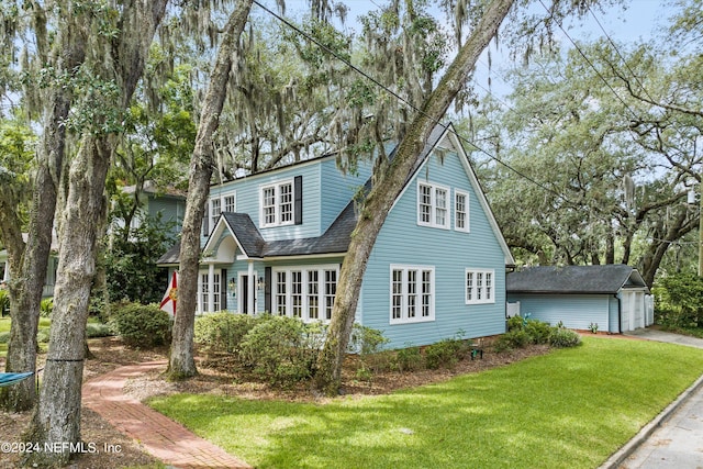 exterior space featuring a front yard, an outdoor structure, and a garage