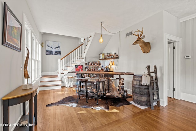 interior space featuring pendant lighting and hardwood / wood-style floors