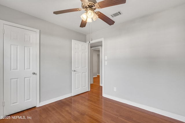 unfurnished bedroom featuring ceiling fan and hardwood / wood-style floors