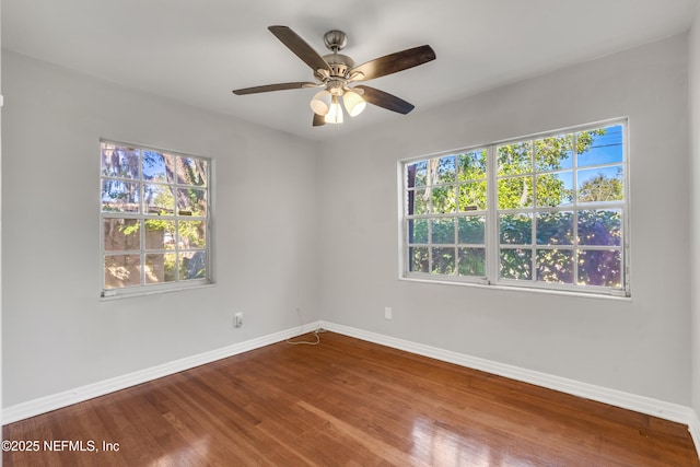 empty room with ceiling fan and hardwood / wood-style floors