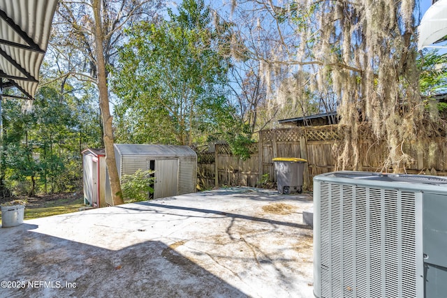 view of patio with a storage shed and central air condition unit