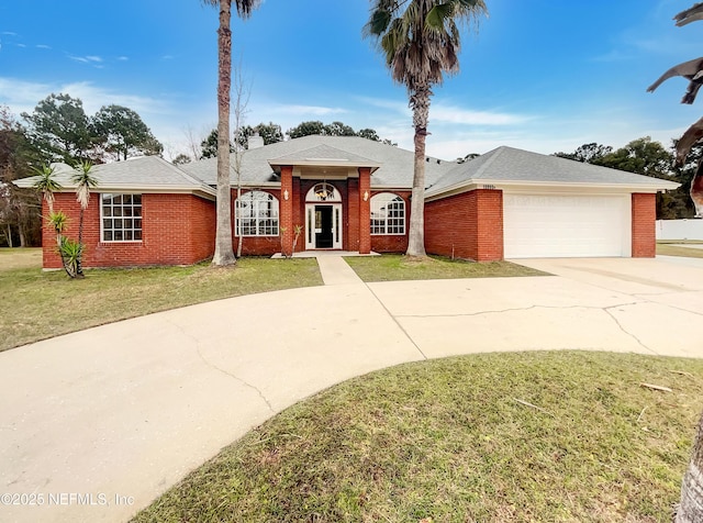 ranch-style house featuring a garage and a front yard