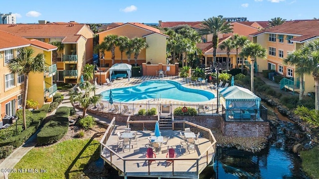 view of pool featuring cooling unit and a patio