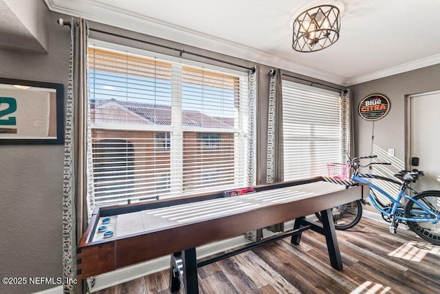 playroom with hardwood / wood-style flooring, ornamental molding, and a chandelier