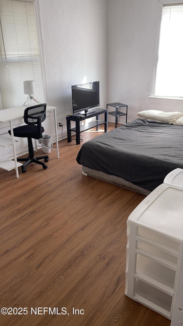 bedroom with dark hardwood / wood-style flooring