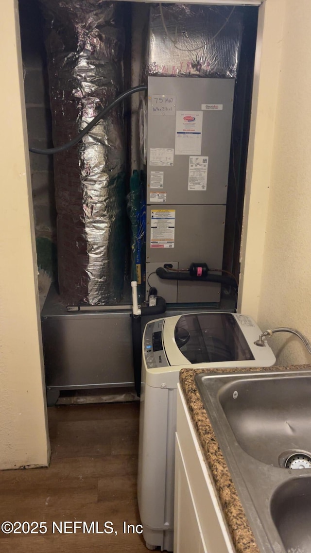 laundry room with dark hardwood / wood-style floors and washer / dryer