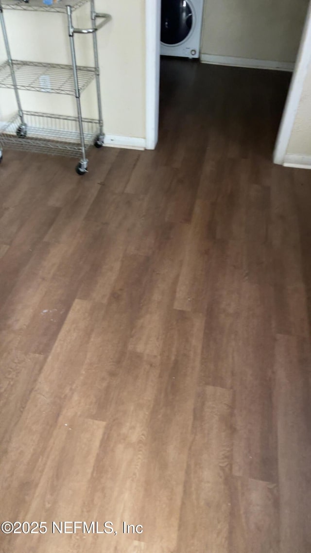 details featuring wood-type flooring and washer / dryer