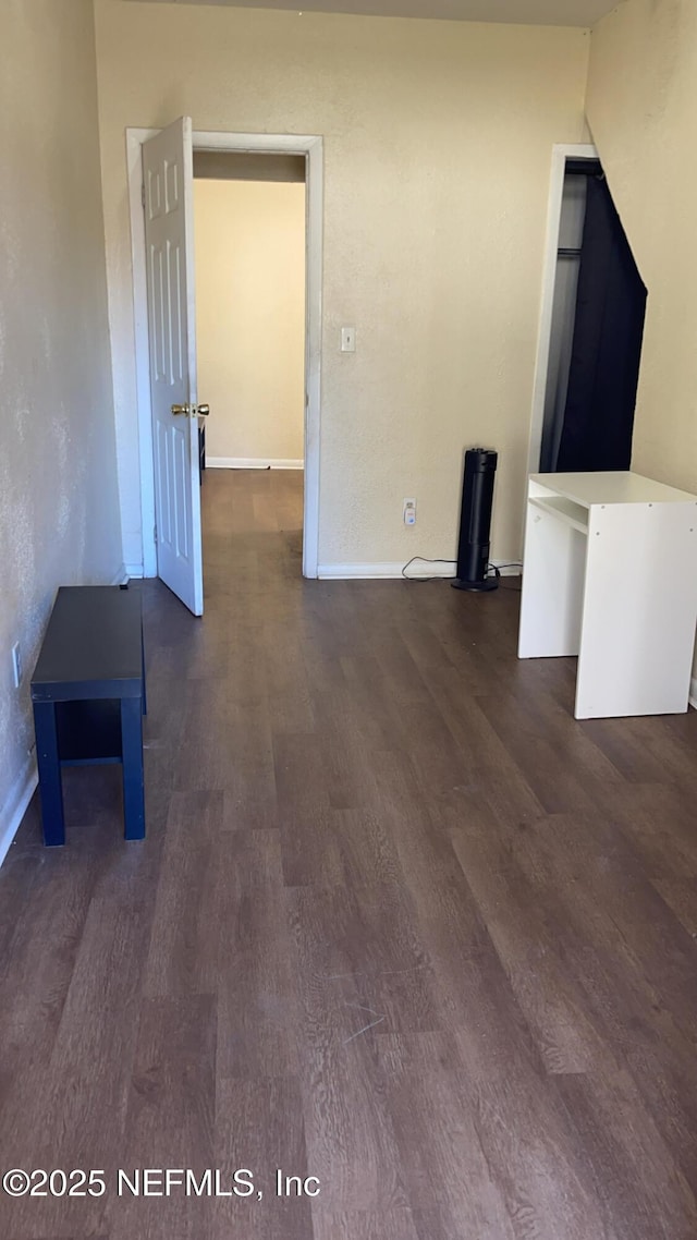 unfurnished living room with dark hardwood / wood-style floors