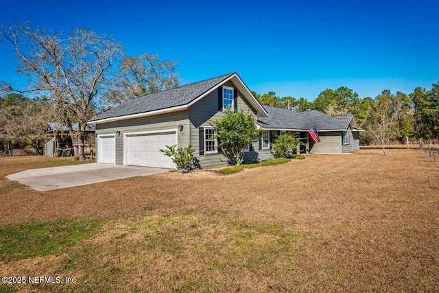 view of front of home with a front yard and a garage