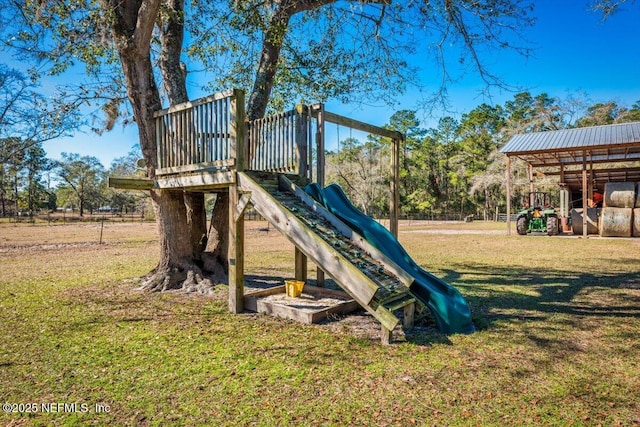 view of jungle gym featuring a lawn