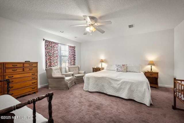 carpeted bedroom with a textured ceiling and ceiling fan