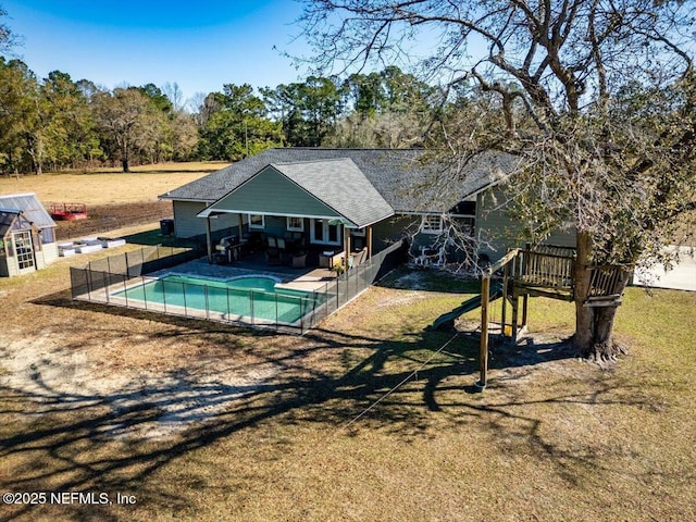 view of pool with a lawn and a patio