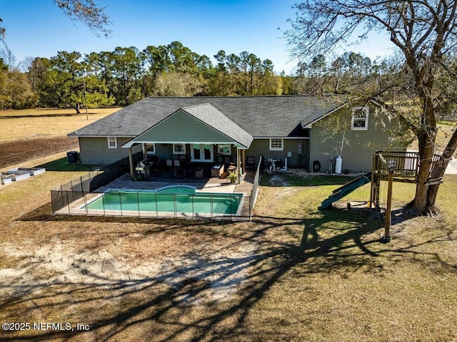 view of pool with a yard and a playground